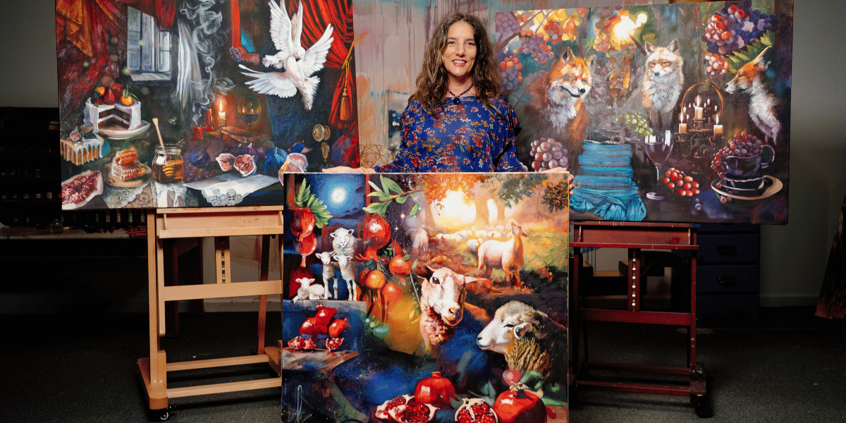 Woman sanding with painting in room surounded but other paintings